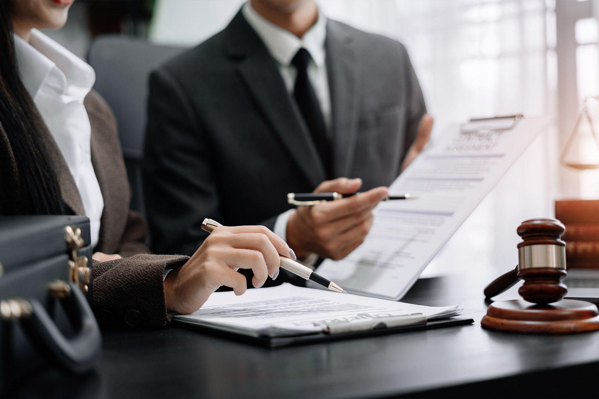 business attorney advising small company owner in florida office meeting