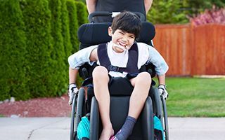 A smiling boy in a wheelchair