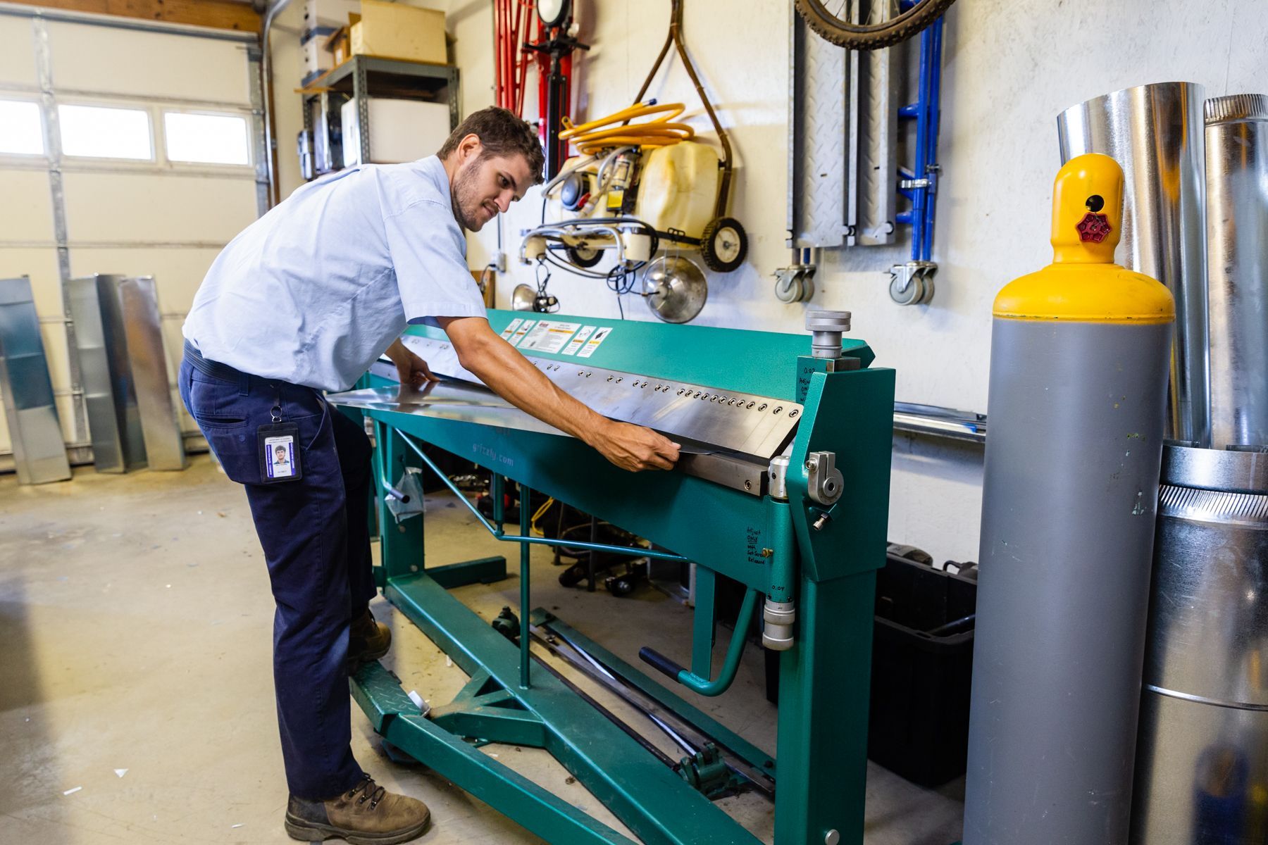 A man is working on a machine in a garage.