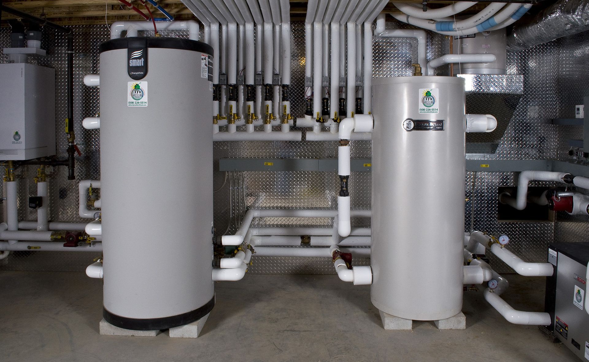 A white air conditioner is sitting on the side of a building.