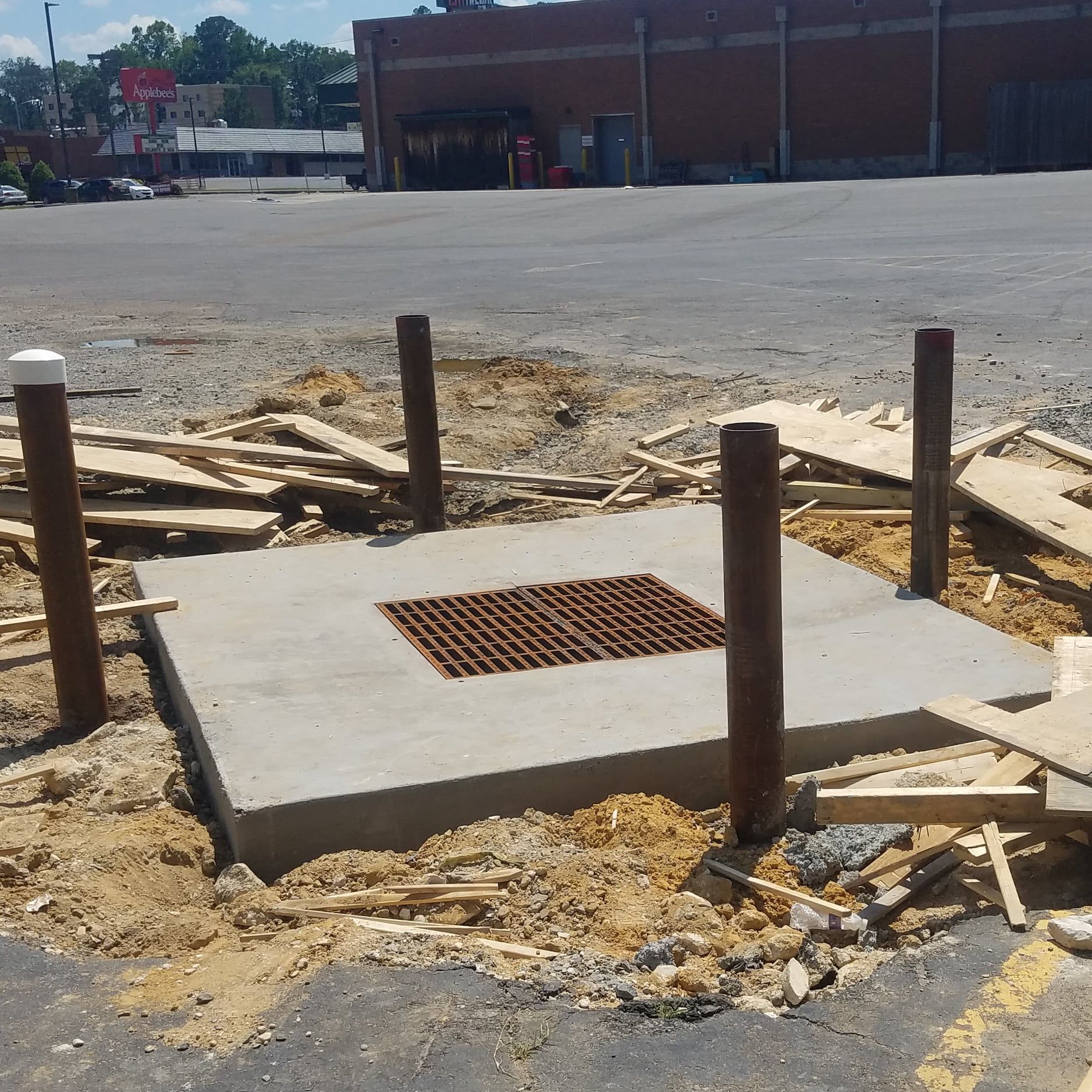 A concrete block with a metal grate on top of it