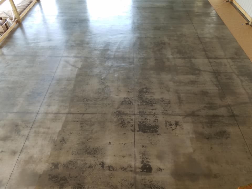 A concrete floor with a lot of stains on it