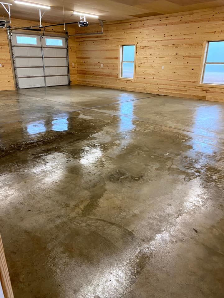 A garage with a concrete floor and wooden walls.
