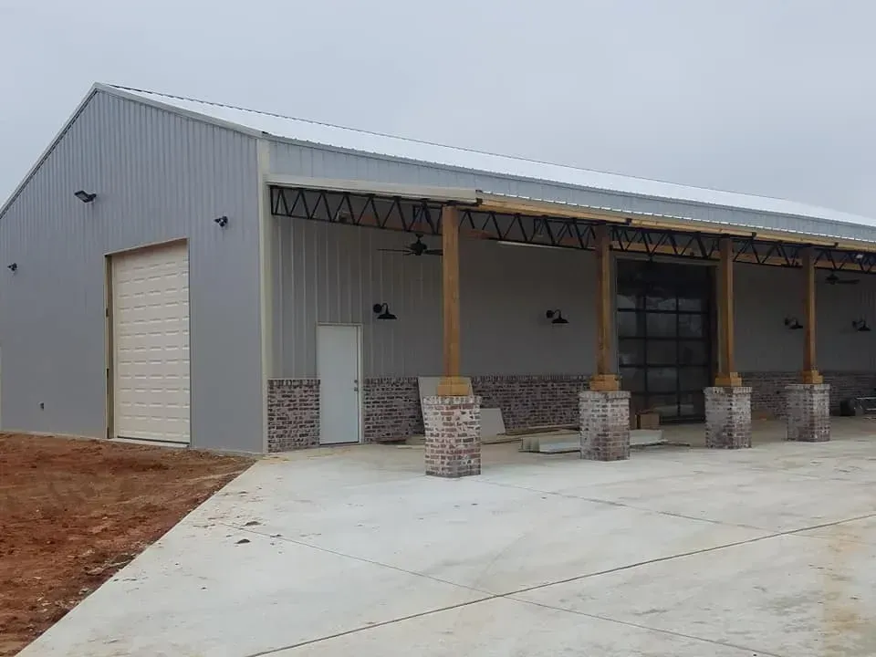 A large building with a covered porch and a garage door