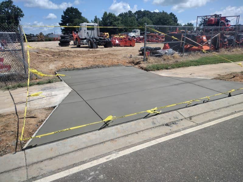 A concrete driveway is being built next to a road.