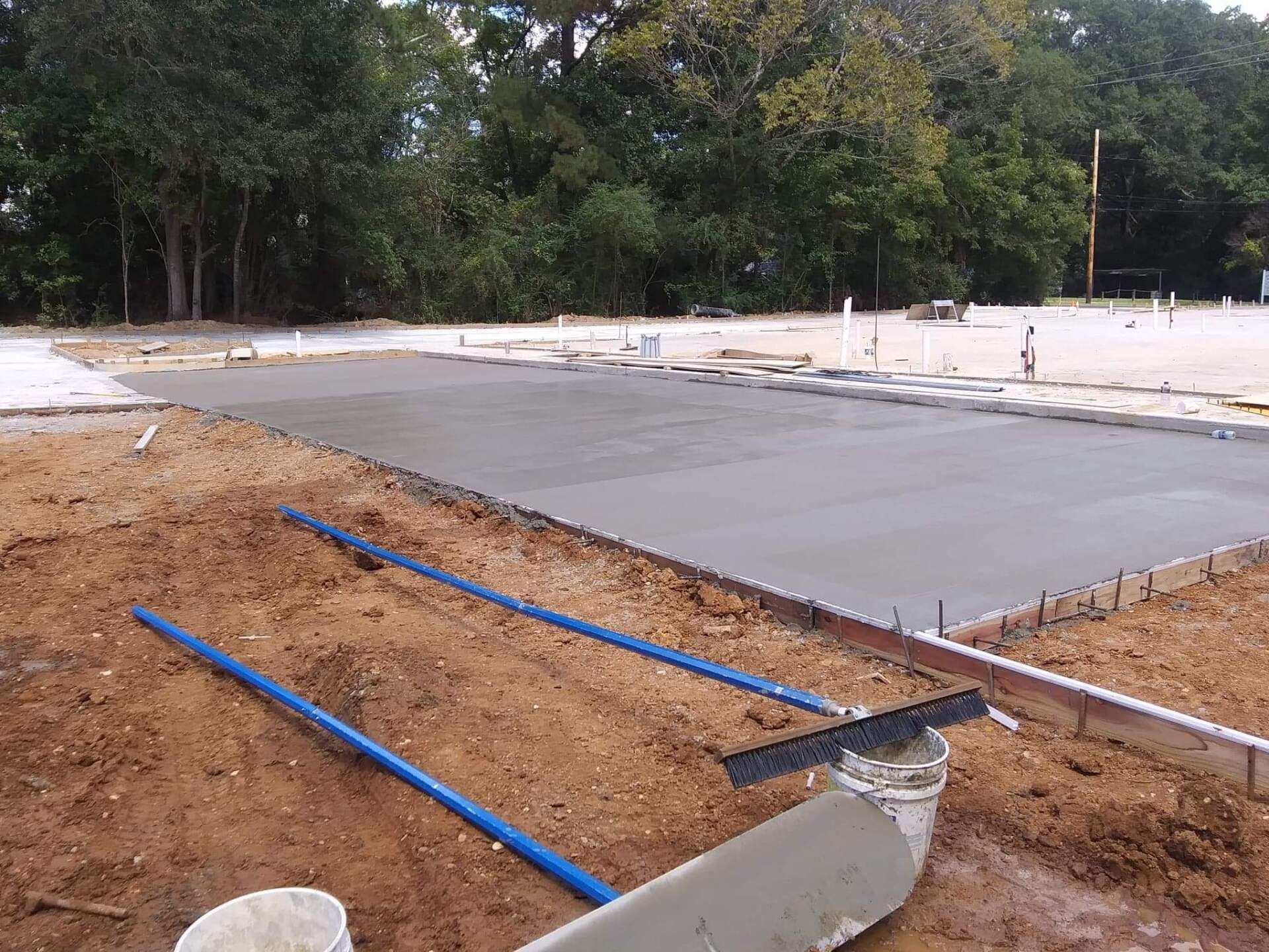 A concrete slab is being poured on a construction site