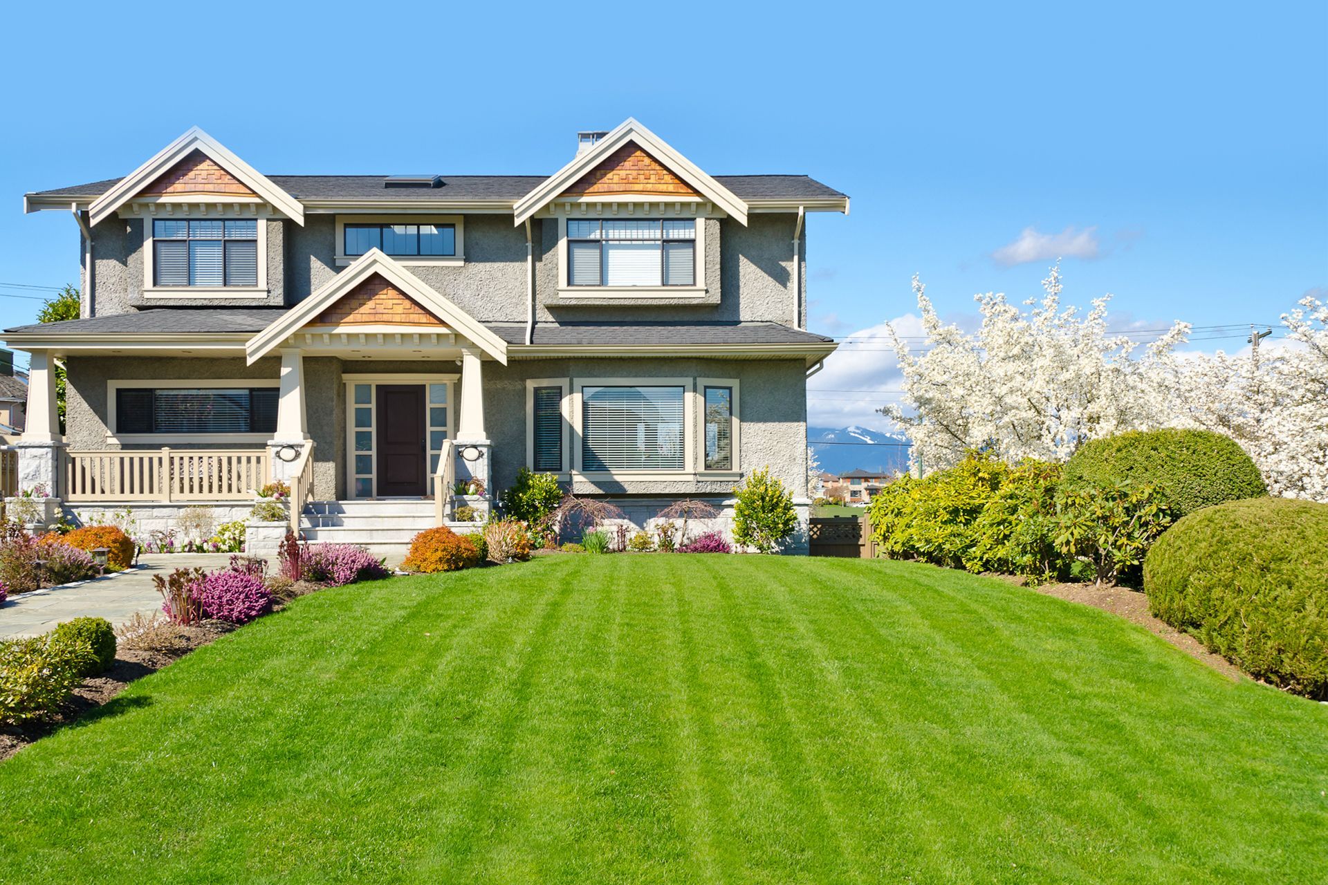 A large house with a lush green lawn in front of it