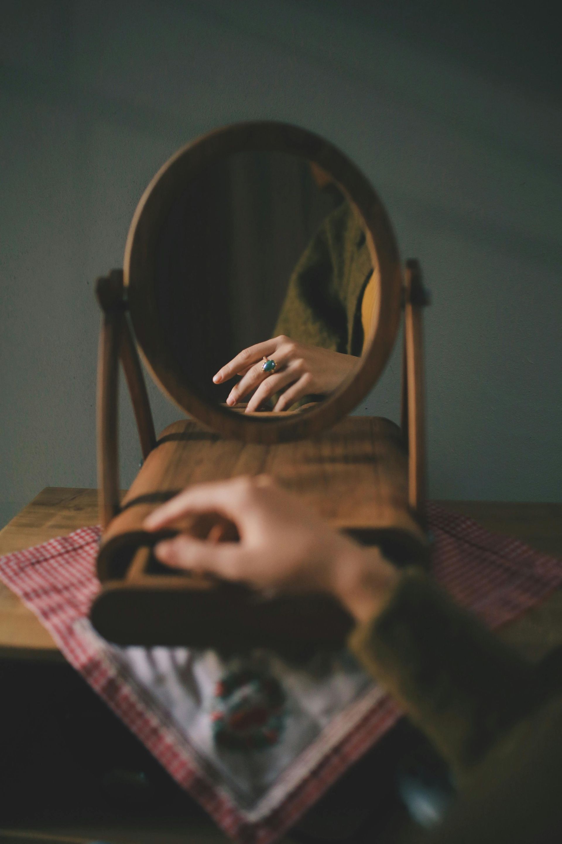 A person is looking at their reflection in a mirror.
