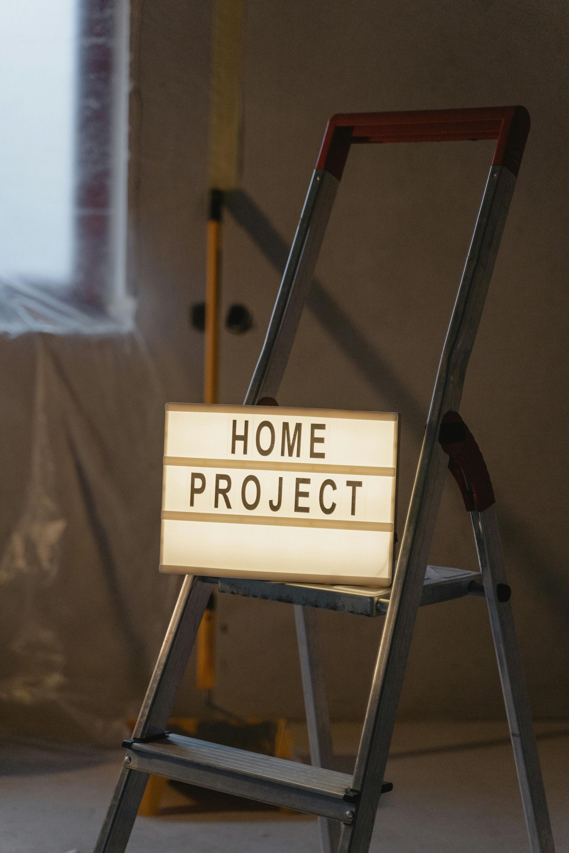 A ladder with a sign on it that says home project