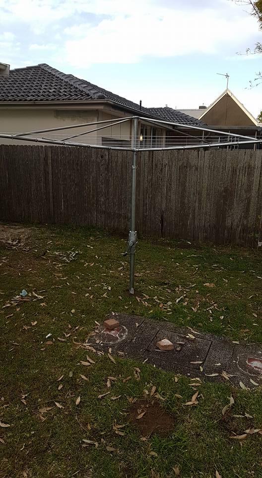 A Clothes Line in a Backyard With a Wooden Fence — South Coast Clothes Lines in Gerringong, NSW