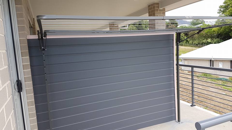 A Balcony With a Gray Wall and a Metal Railing — South Coast Clothes Lines in Gerringong, NSW