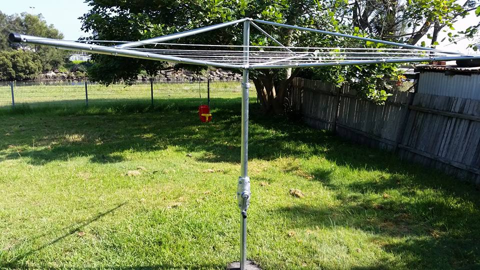 A Clothes Line is Sitting in the Middle of a Lush Green Field — South Coast Clothes Lines in Gerringong, NSW