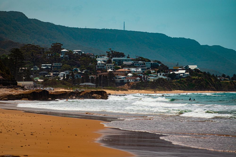 A Beach With a Mountain in the Background and a City— Washing Line in Thirroul, NSW