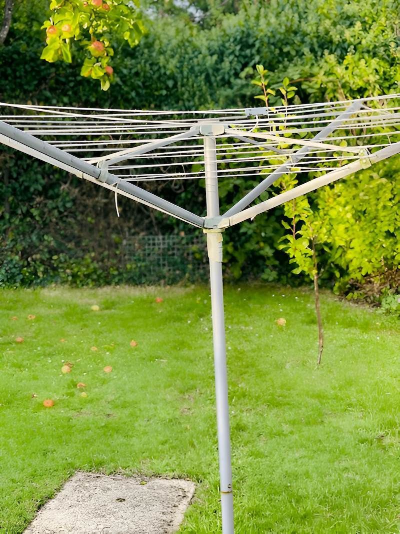 A Clothes Line is Sitting in the Middle of a Lush Green Yard — South Coast Clothes Lines in Thirroul, NSW