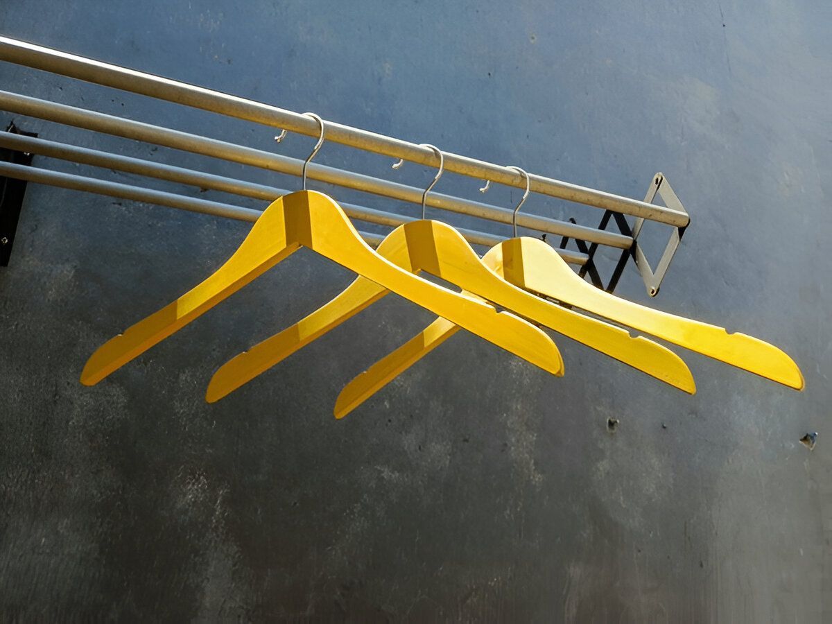 A Bunch of Yellow Hangers Hanging on a Rack — South Coast Clothes Lines in Dapto, NSW