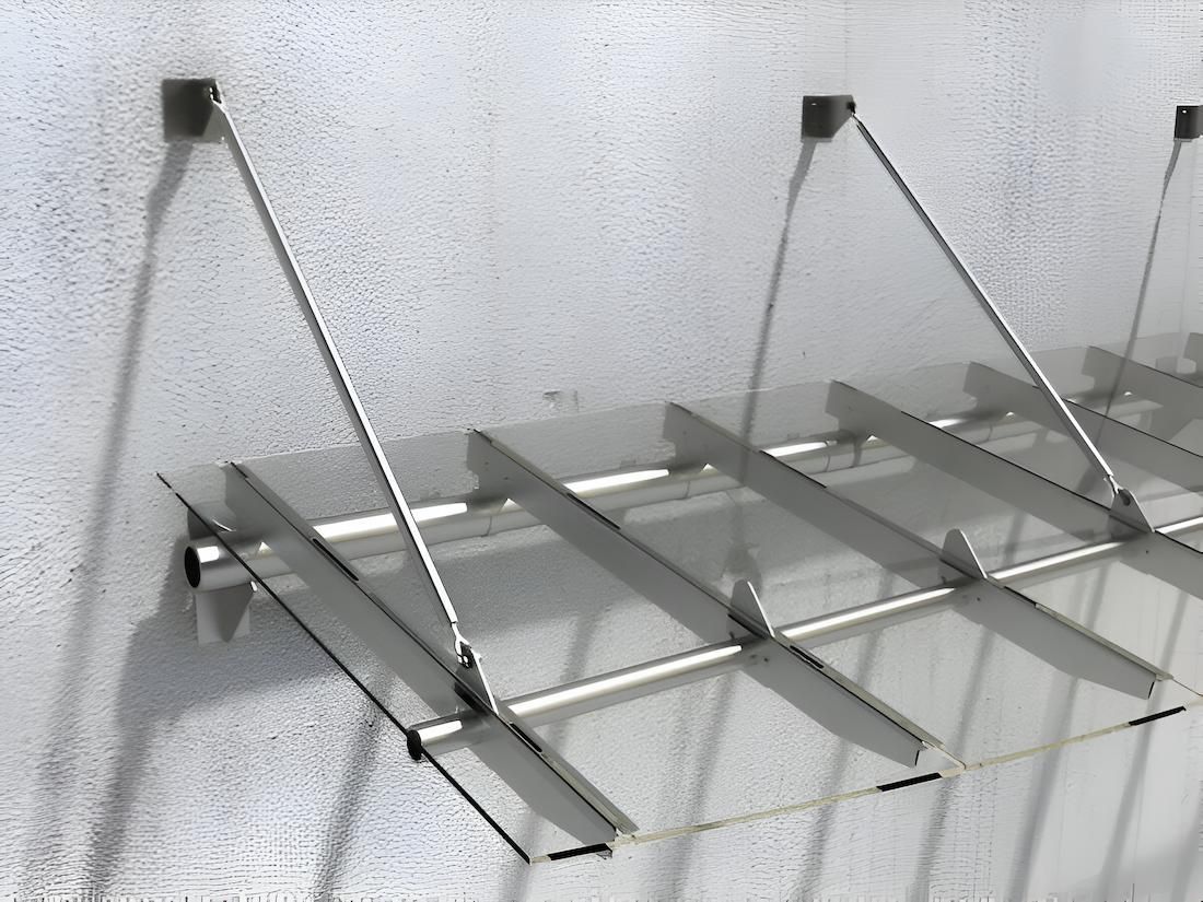 A Stainless Steel Canopy is Attached to a White Wall — South Coast Clothes Lines in Thirroul, NSW