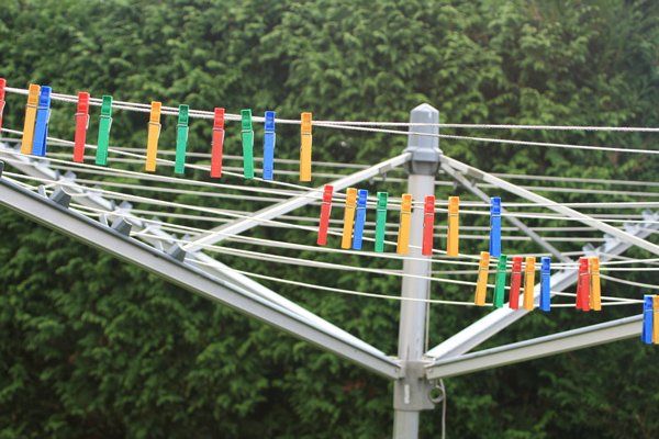 A Clothes Line With Colourful Clothespins Hanging on It — South Coast Clothes Lines in Nowra, NSW