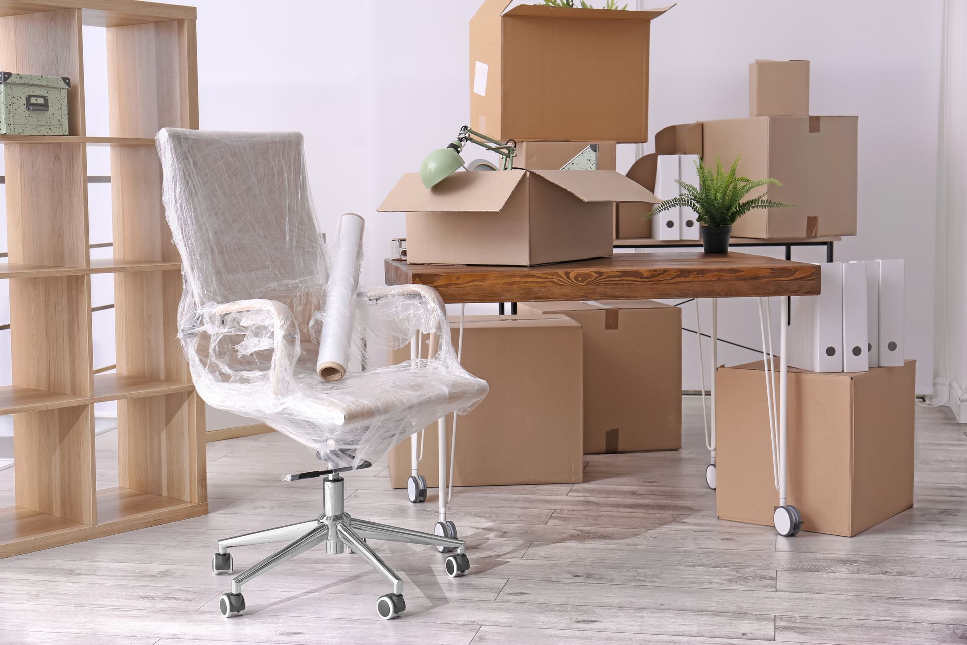 chair and moving boxes in office room