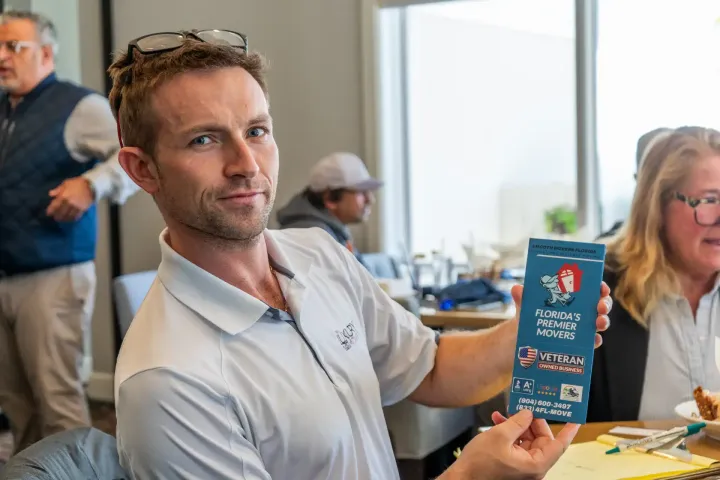 Beachside Mavericks member sharing promotional materials during a networking event