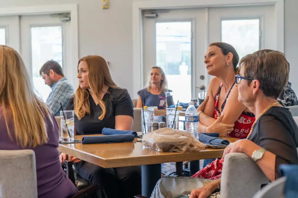 Beachside Mavericks members engaged in a collaborative business discussion