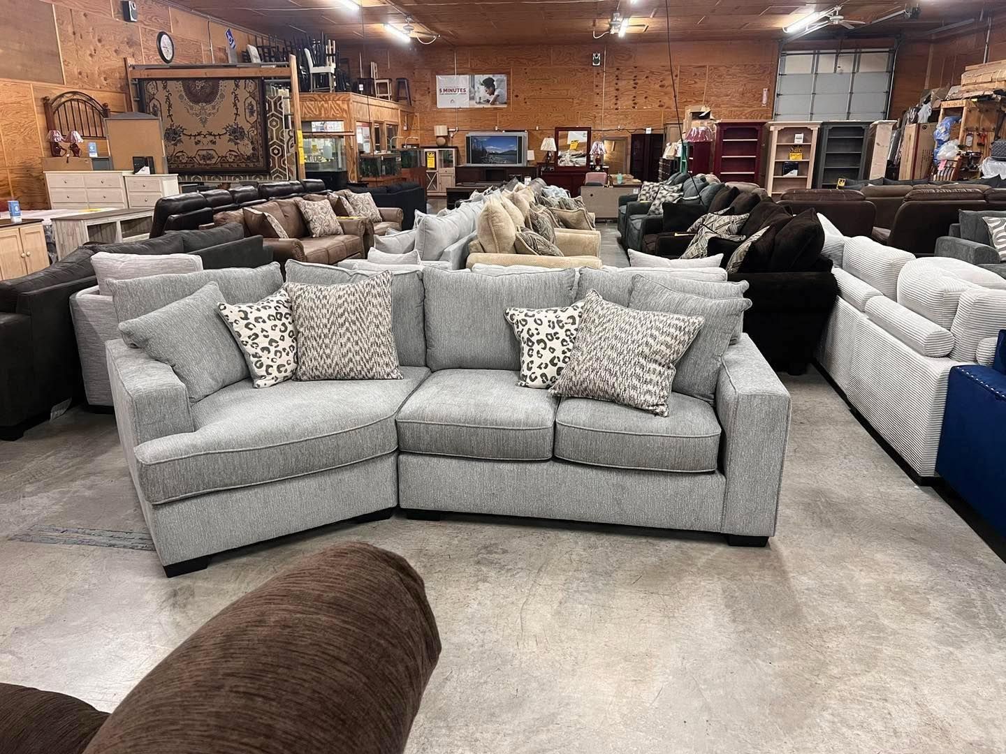 A large room filled with lots of couches and chairs.