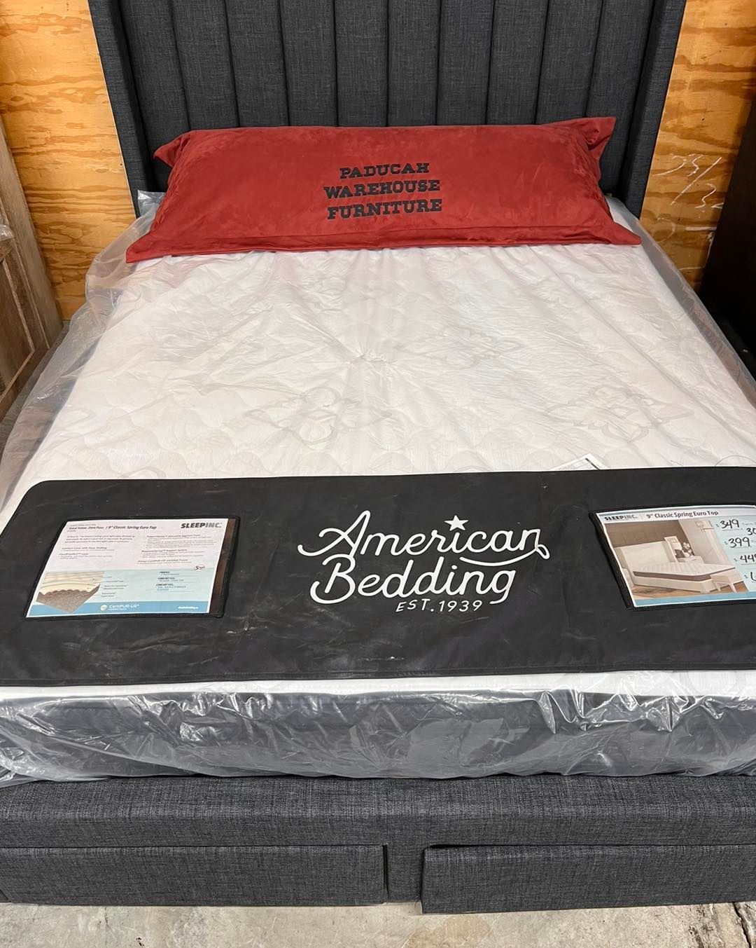 A mattress is sitting on top of a bed in a store.