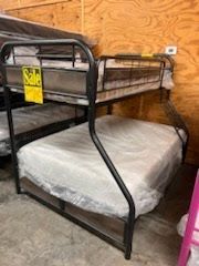 A bunk bed with a mattress underneath it is for sale in a store.