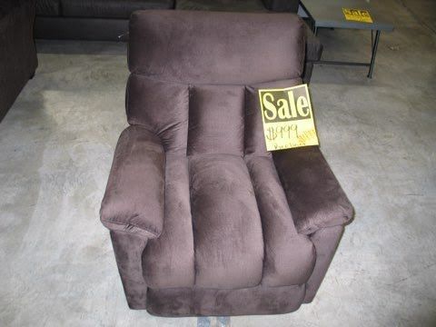 A brown recliner with a sale sign on it