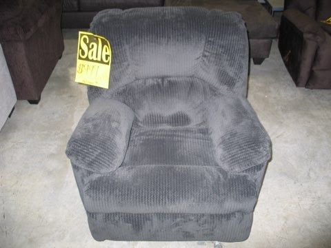 A black recliner with a sale sign on it
