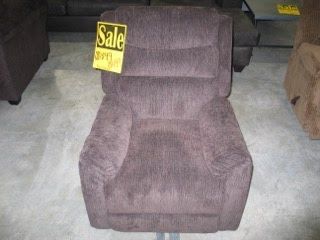 A brown recliner with a sale sign on it