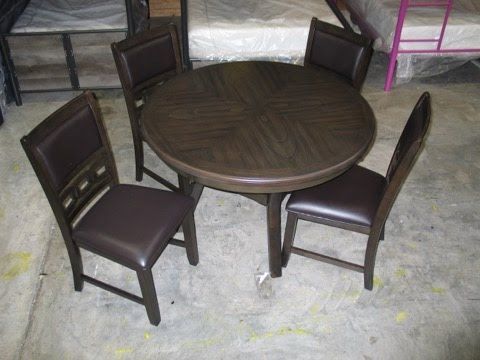 A table and chairs are sitting on a concrete floor.