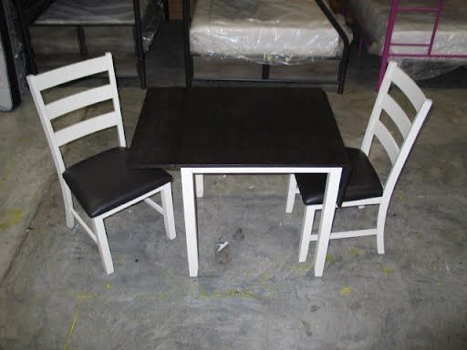 A table and chairs are sitting on a concrete floor.