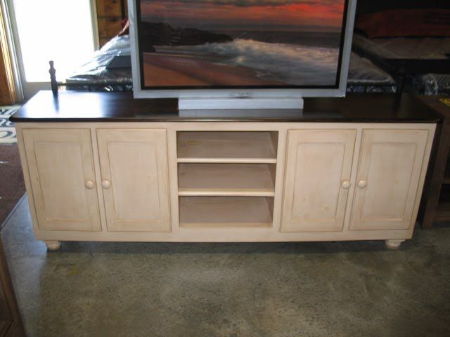 A flat screen tv is sitting on top of a wooden entertainment center