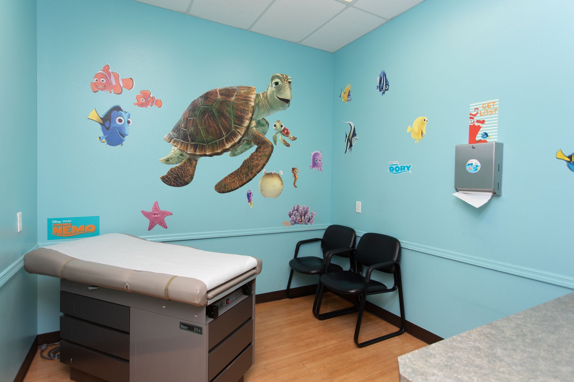 A doctor 's office with a turtle on the wall.