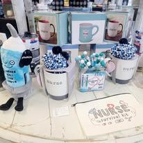 Various nurse-themed mugs, gifts, and boxes on display.