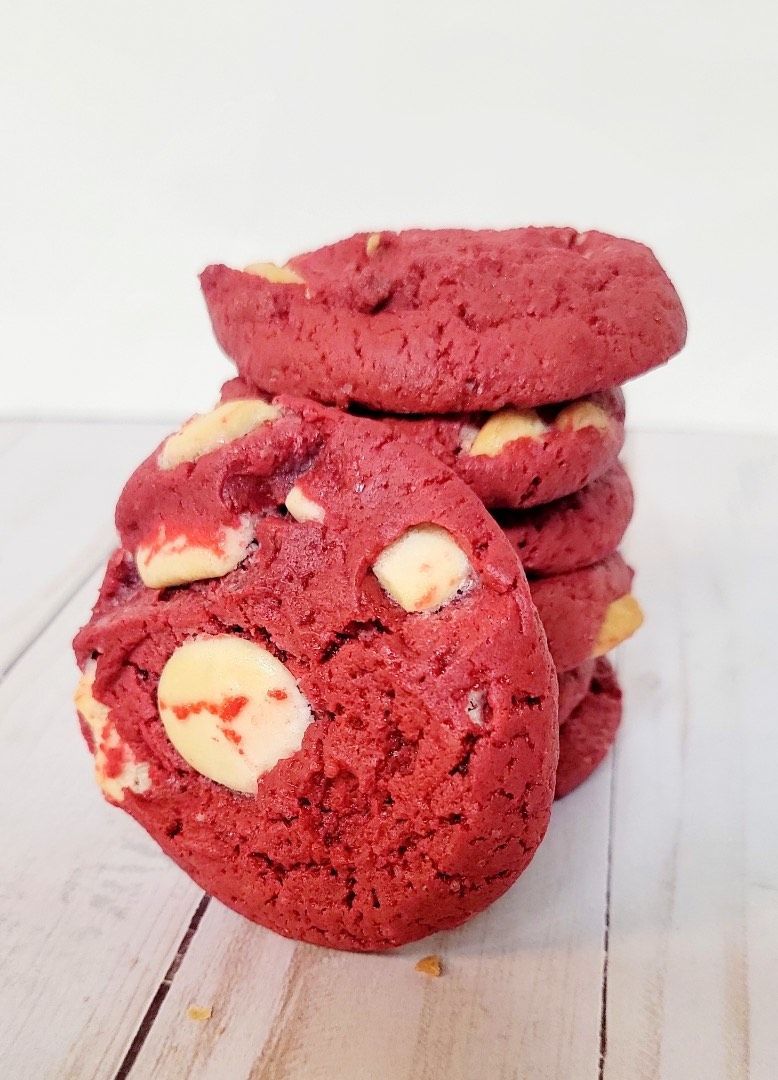 Stack of red velvet cookies with white chocolate chips.