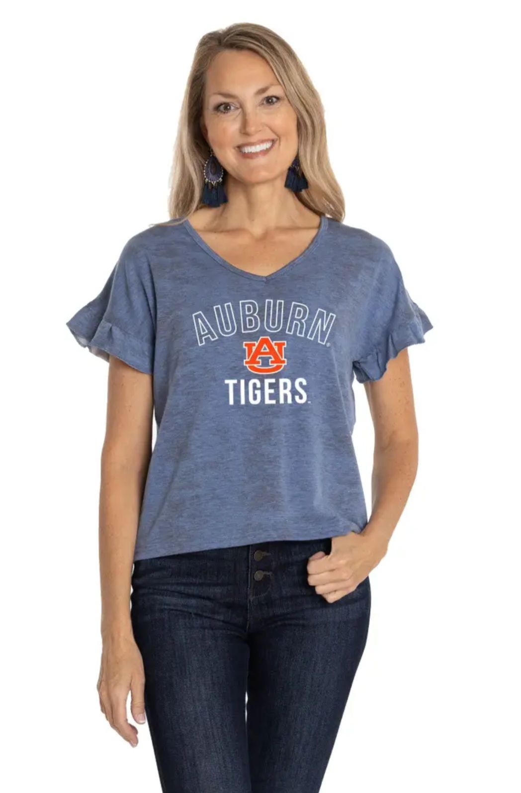 Woman in Auburn Tigers blue shirt, jeans, smiling.