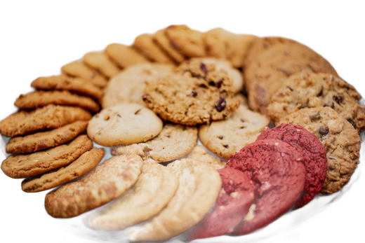Assorted cookies of various shapes and colors arranged on a white plate.