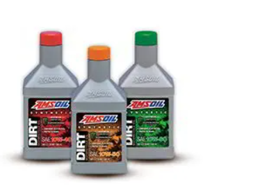 four bottles of amsoil dirt oil are sitting next to each other on a white surface .