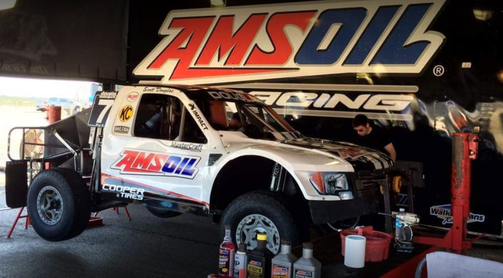 an amsoil truck is being worked on in a garage