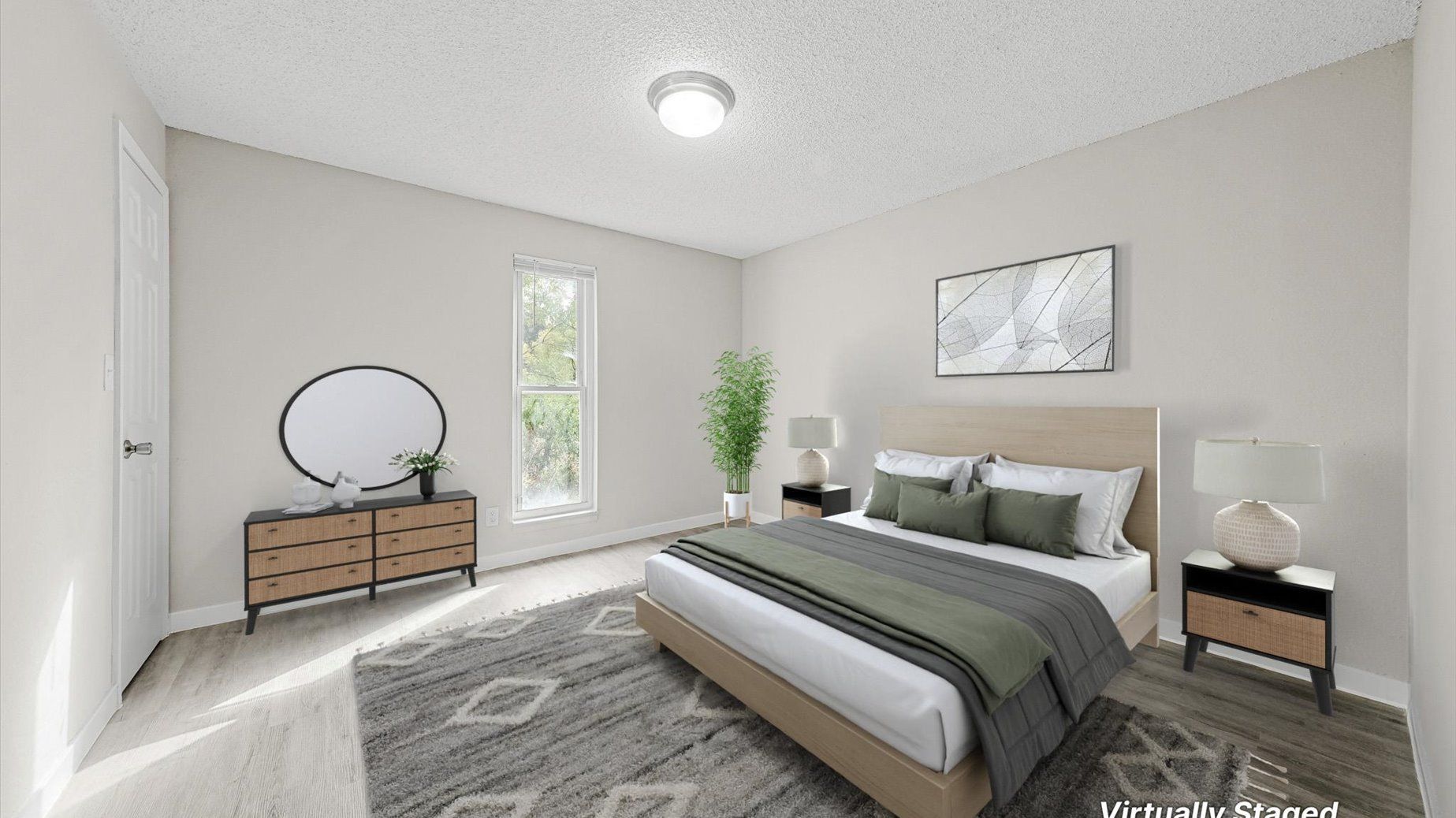 Bedroom in a modern apartment with a bed, dresser, nightstands, and plant.