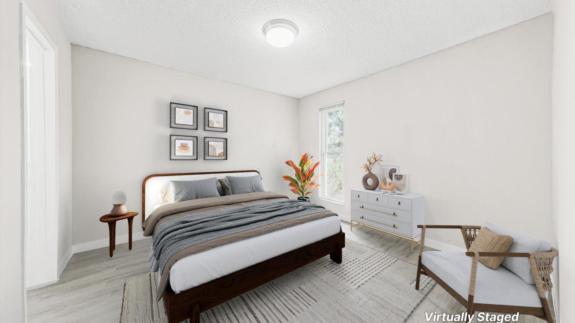 Bedroom interior in a modern apartment with a wooden bed, dresser, chair, and window.