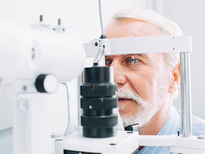 Optometrist — Senior man getting eye exam in Highland, IN