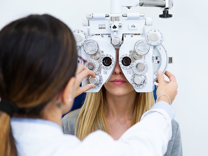 Vision Testing — Young Woman Sitting with the Optician in Highland, IN