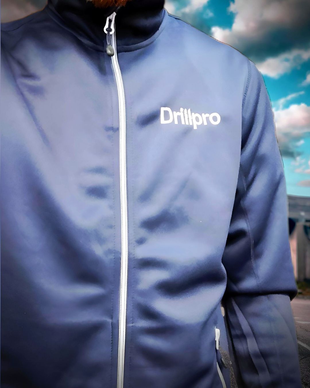 A man wearing a blue jacket with the word drillpro on it