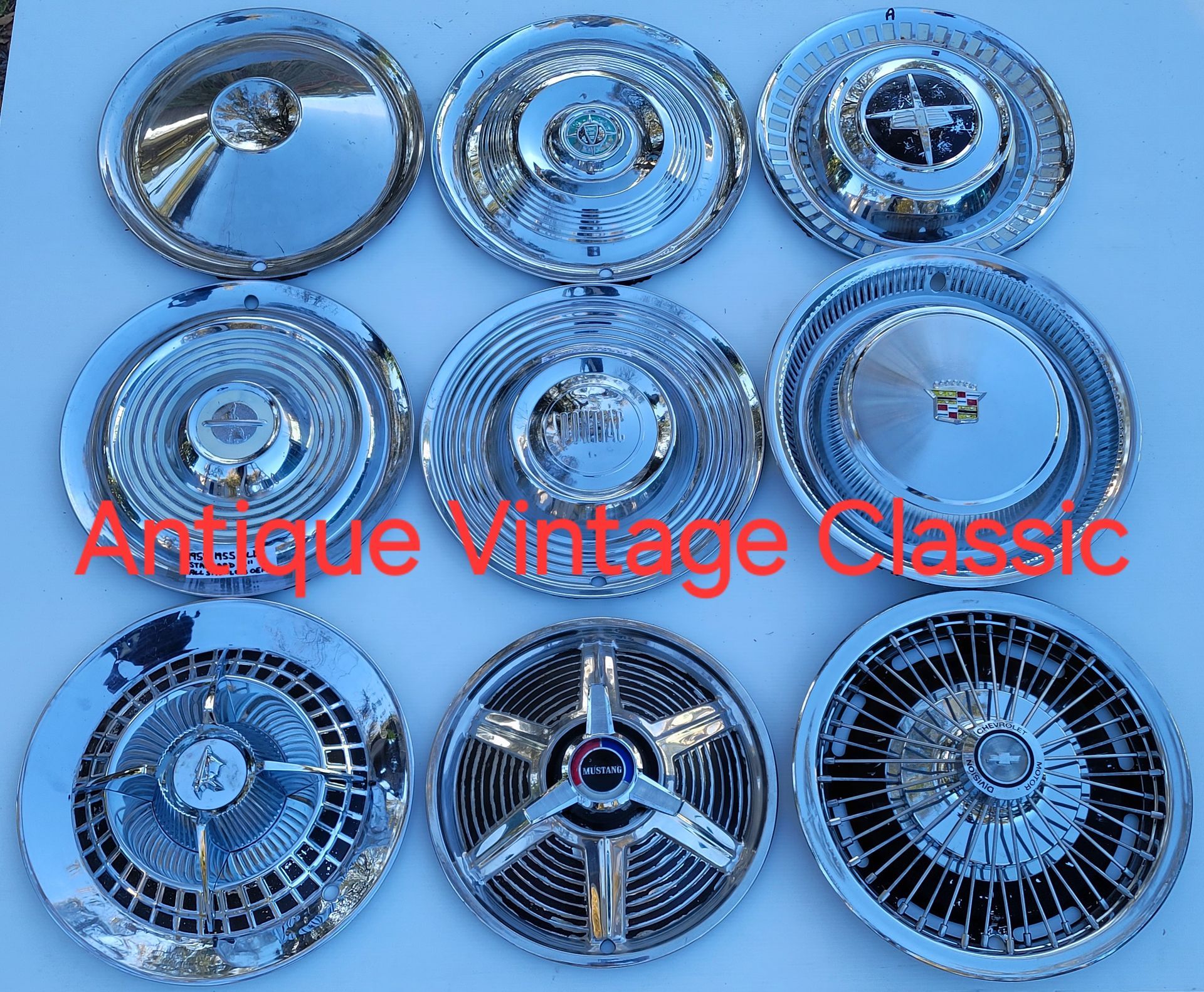 Scattered assortment of black, silver, and red lug nuts. Scattered assortment of black, silver, and red lug nuts.