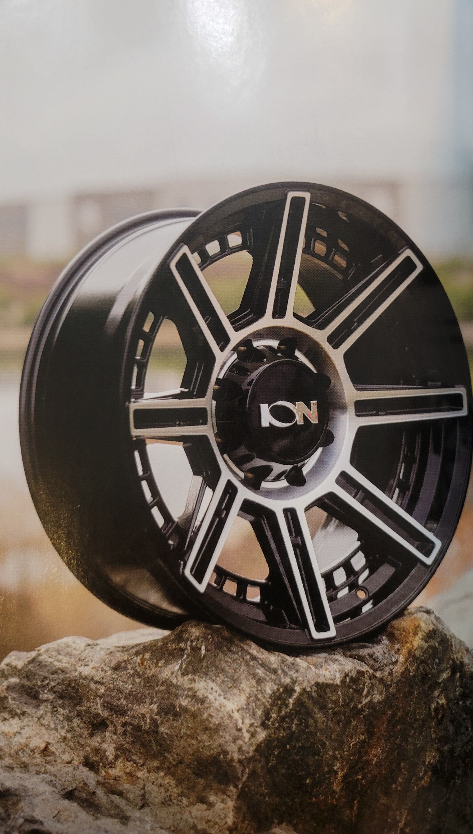 Chrome alloy wheel on a silver car, with blue details. Chrome alloy wheel on a silver car, with blue details.