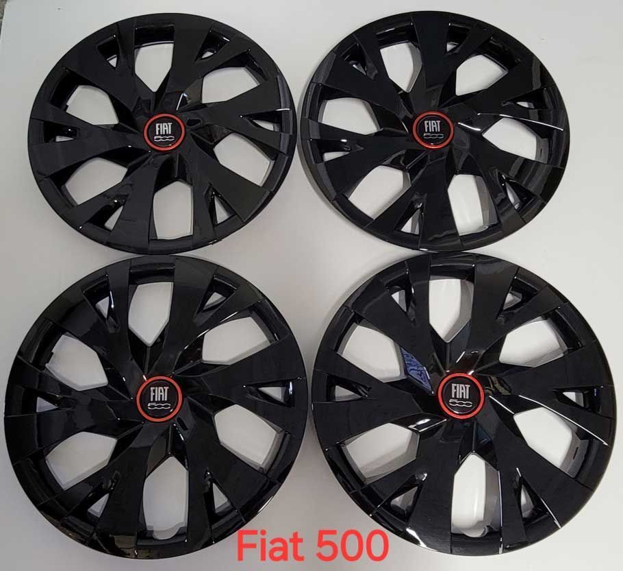 Four black Fiat 500 wheel covers with a red Fiat logo on a white surface.
