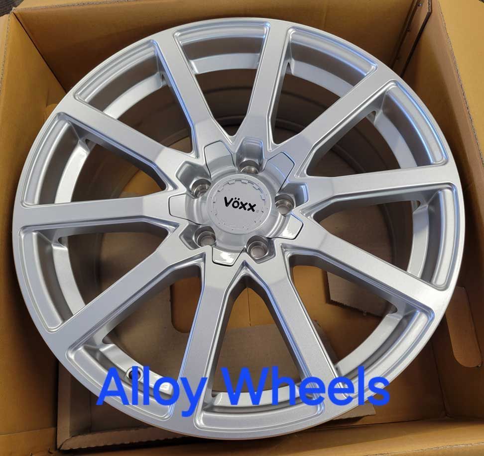 Silver alloy wheel with the Voxx logo inside a cardboard box. Silver alloy wheel with the Voxx logo inside a cardboard box.