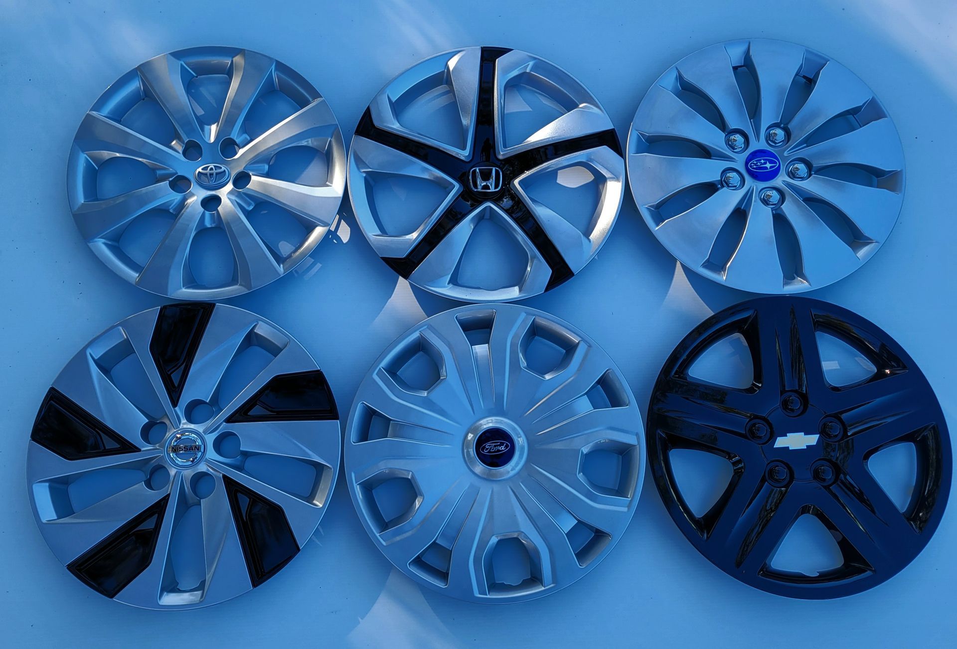 White cargo van with chrome wheels in a parking lot. White cargo van with chrome wheels in a parking lot.